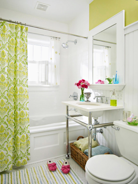 A bathroom with a vibrant green and elegant white shower curtain.
