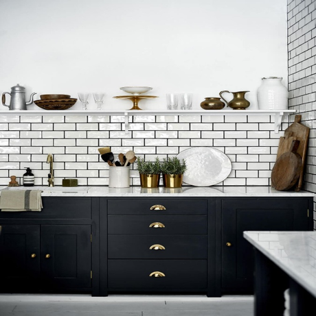 A monochromatic kitchen with gold hardware.
