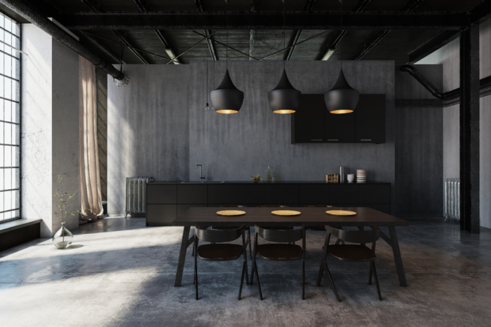Industrial kitchen with black table and chairs.