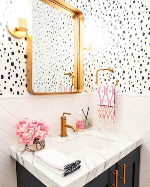 A bathroom with polka dot wallpaper.