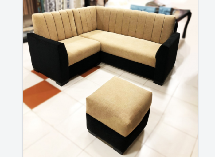 A tan and black sectional sofa set in a store with small space hacks to décor.