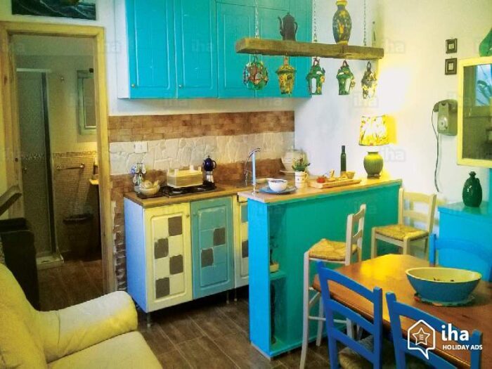 A kitchen with blue cabinets and a table and chairs: Kitchen cabinet color ideas.
