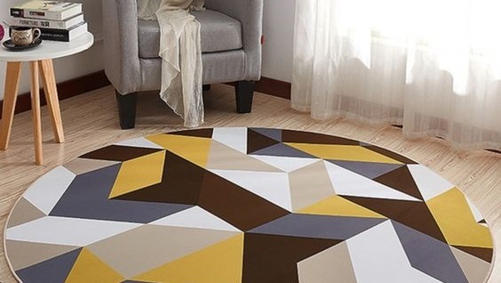 A yellow geometric rug in a living room.