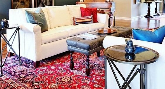 A living room with a rug and chairs furnished with carpets.