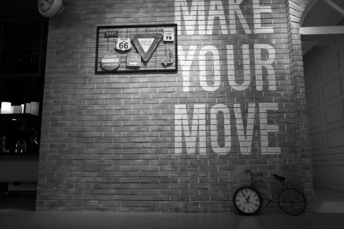 A black and white photo of a brick wall featuring wall décor ideas.