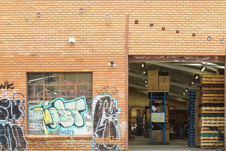A graffiti-covered brick building as an inspiration for wall décor ideas.