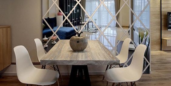 A dining room with a white table and chairs influenced by feng shui.