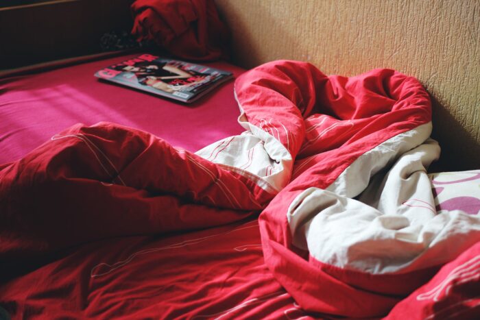 Red blanket on bed.