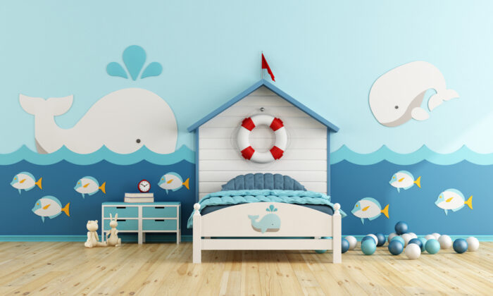 A child's bedroom with a blue wall and a bed.