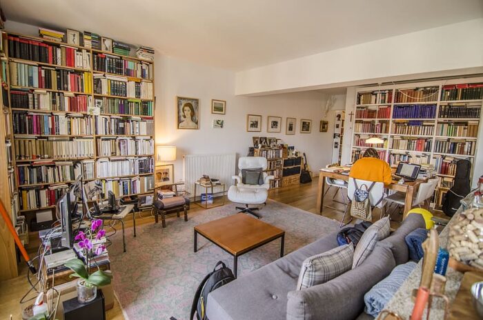 A living room with an abundance of bookshelves, perfect for wall décor ideas.