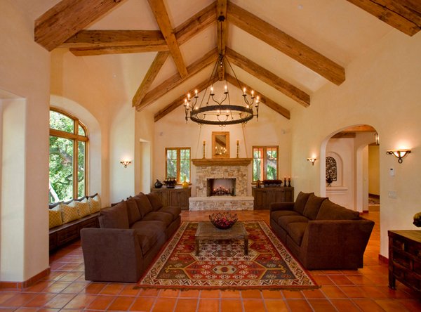 Tuscan-inspired living room with wood beams and a fireplace.