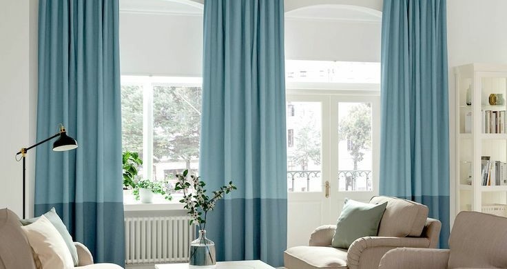 A living room with blue curtains, decorated in spring home decor.