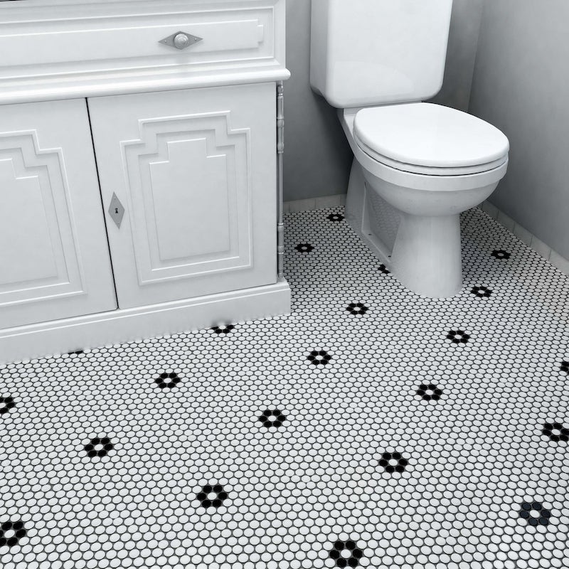 A bathroom with penny tile flooring.