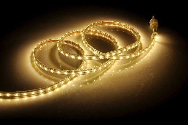 A gold LED strip on a black background featuring LED lights.