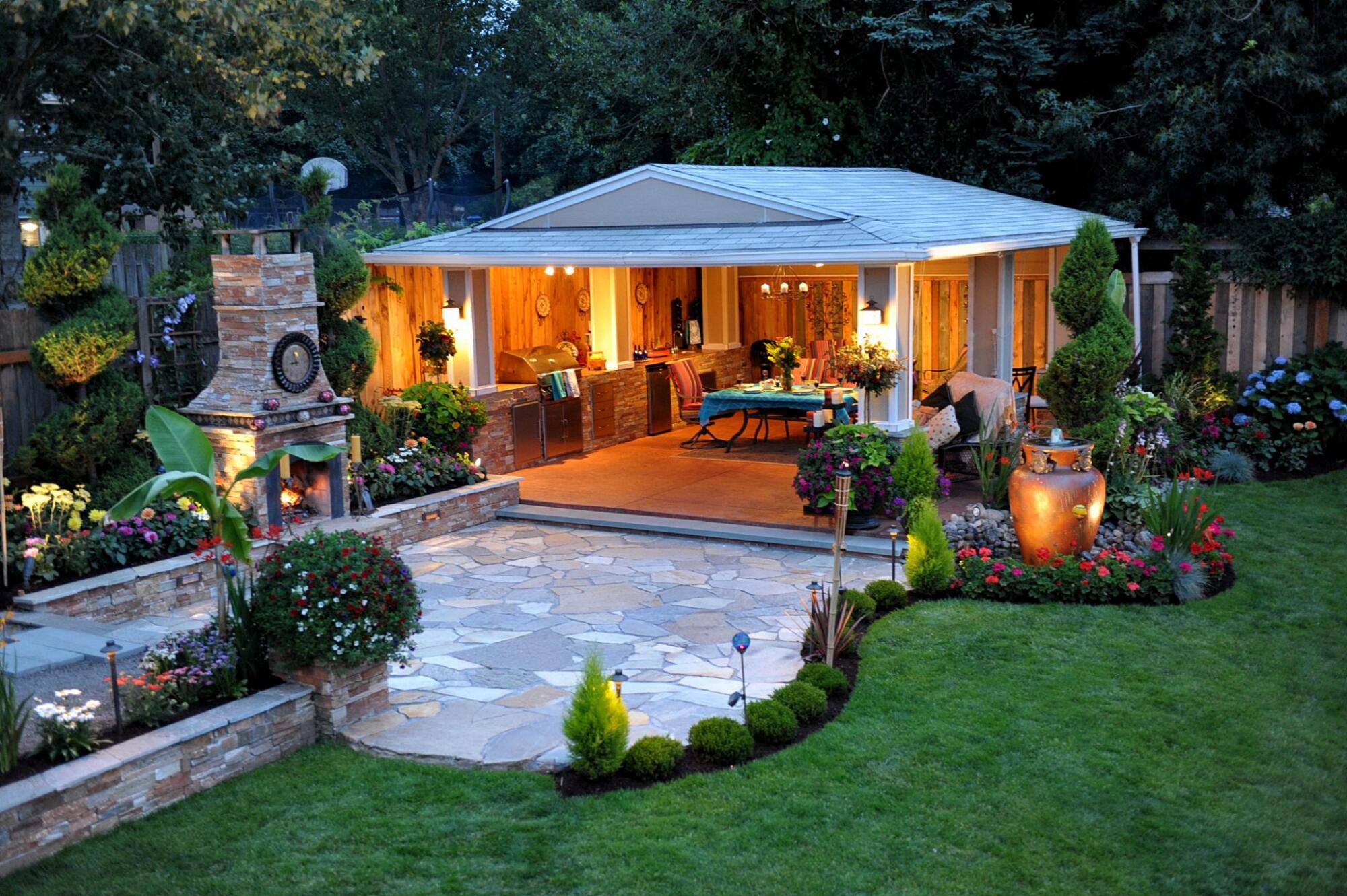 A backyard with an outdoor living space featuring a gazebo and fire pit.