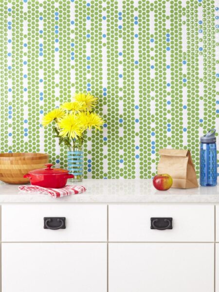 A kitchen with a green and blue tiled backsplash.