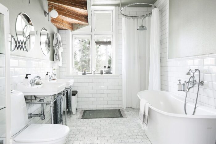 A Scandinavian-style bathroom with a tub and sink.