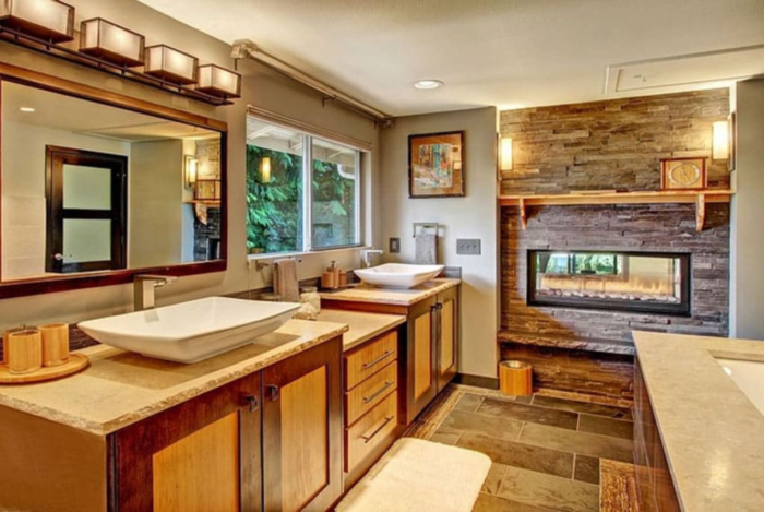A Craftsman-style bathroom with two sinks and a fireplace.