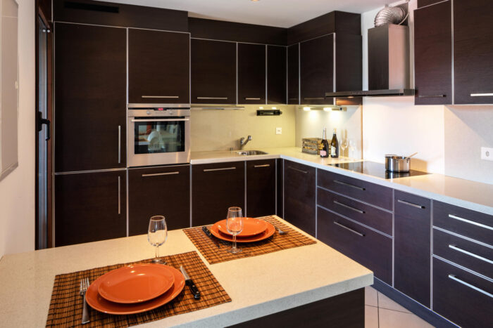 A kitchen with brown cabinets and a peninsula.