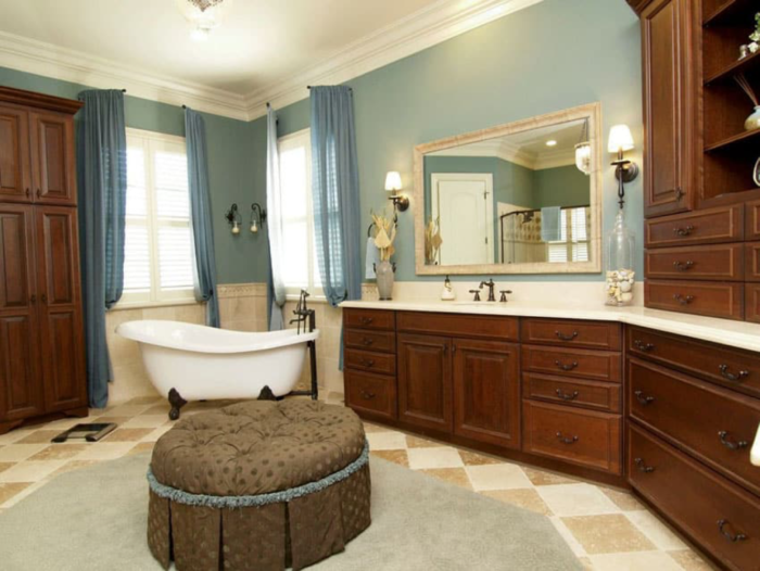 A Craftsman bathroom with blue walls and a bathtub.