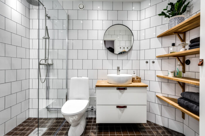 A Scandinavian bathroom with a toilet and sink.