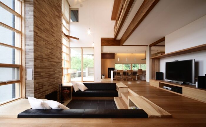 Japanese living room with wooden beams and a flat screen tv.