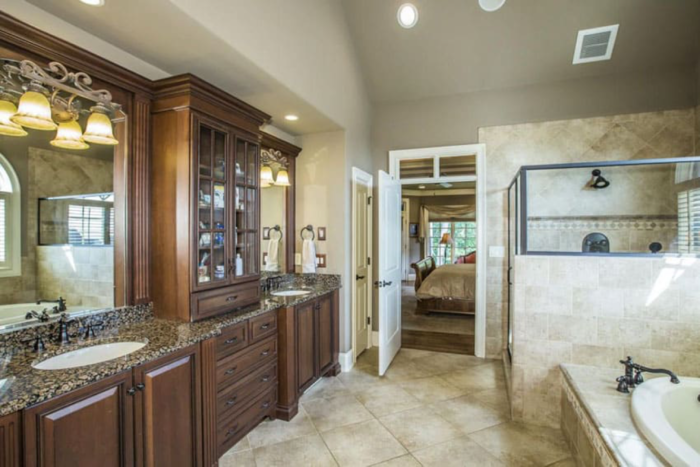A Craftsman-style bathroom featuring granite counter tops and a large tub.
