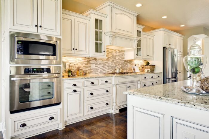 Tasteful antique style kitchen units of wooden materials in white