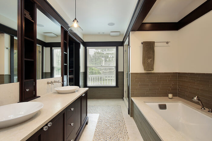 A bathroom with a penny tile bathtub.
