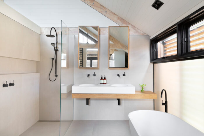 A Scandinavian bathroom with a glass shower.