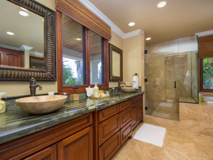 A Craftsman-style bathroom with two sinks and a glass shower.
