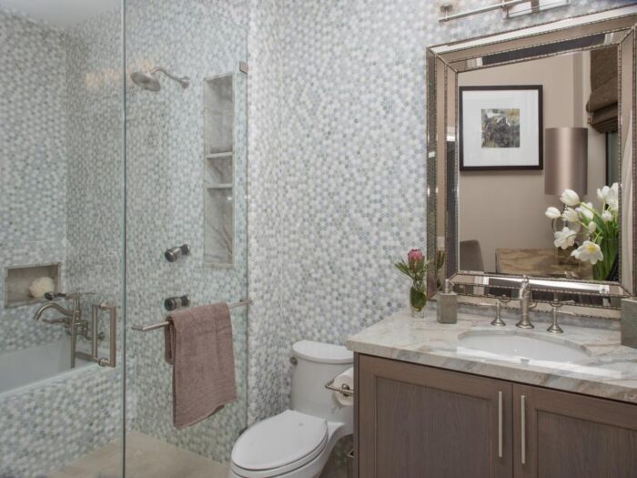 A penny tile bathroom with a glass shower.