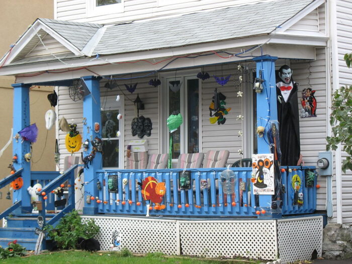 A porch decorated for Halloween with door decor ideas.