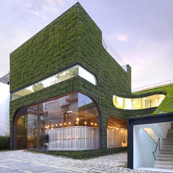 A modern building with a green roof and green wall architecture.