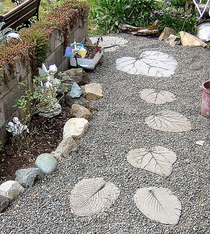 A garden path with rocks and leaves.