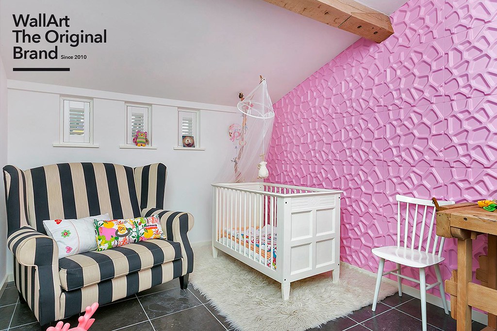 A baby's room with pink walls and a crib.