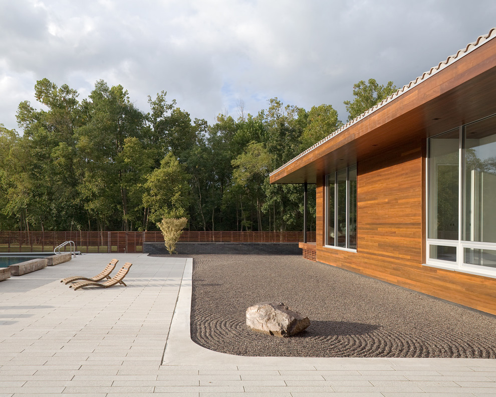 A wooden deck and pool create a modern backyard.