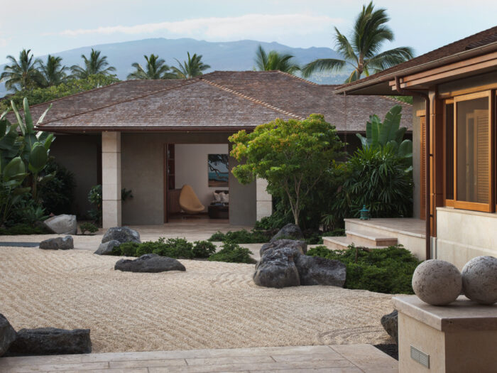 A Zen-inspired stone pathway in front of a house.