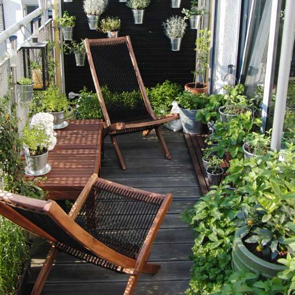 A small balcony with potted plants, perfect for a balcony garden idea.