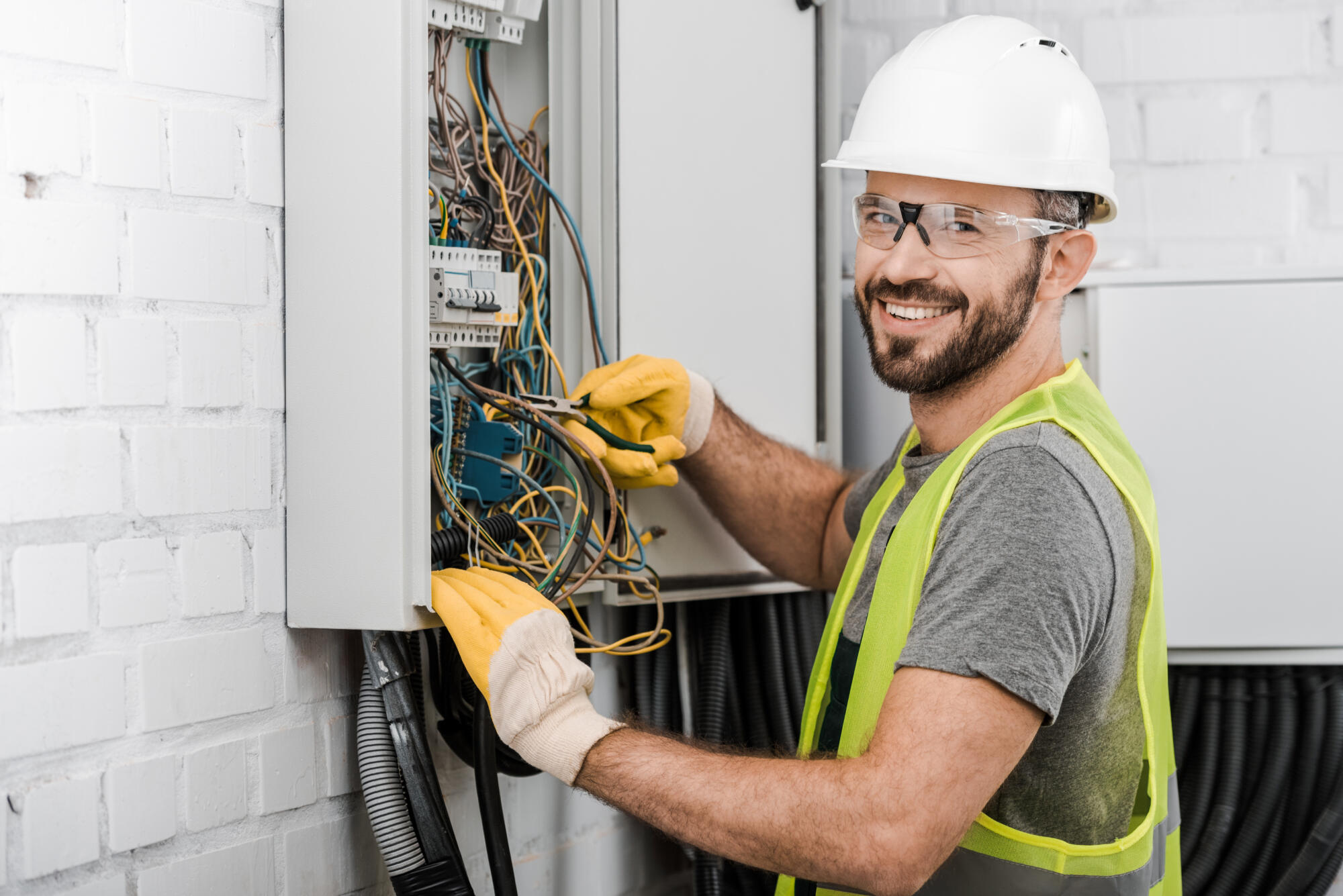 An electrician is working on an electrical panel.
