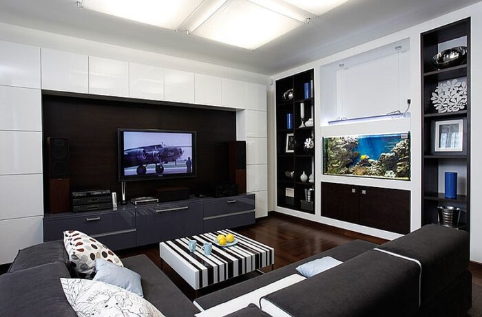 A masculine living room with a TV and a fish tank.