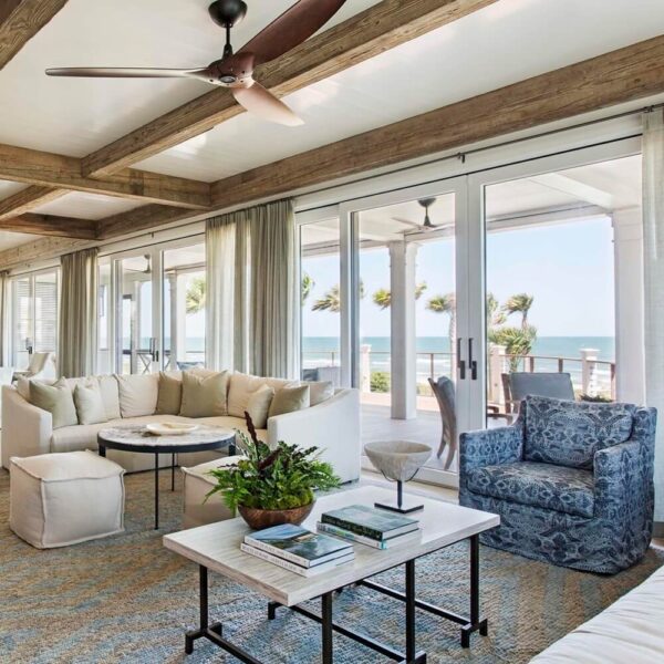 A beach-themed living room with a view of the ocean.