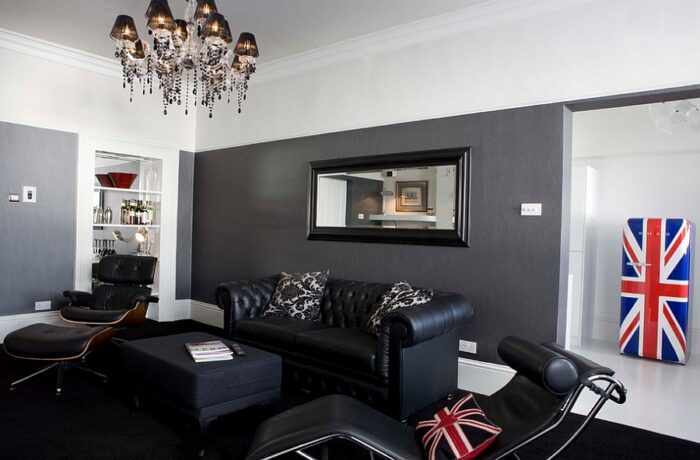 A masculine living room with a British flag on the wall.