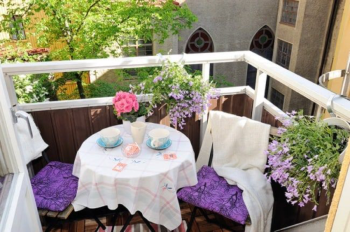 A small balcony with a table and chairs perfect for a garden idea.