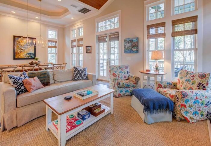 A beach-themed living room with couches and a coffee table.