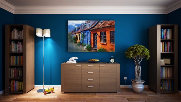 A room with a painting of a vegetable garden on the blue walls.