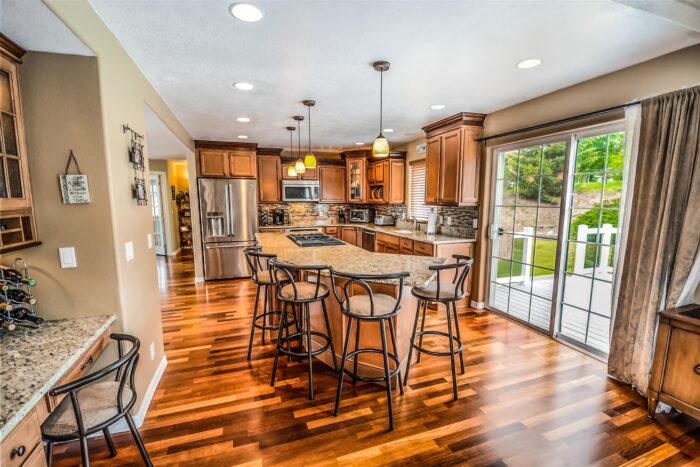 A spacious kitchen with hardwood floors and a large island.