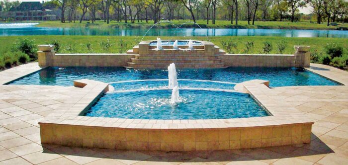 A pool with a fountain incorporating architecture design.