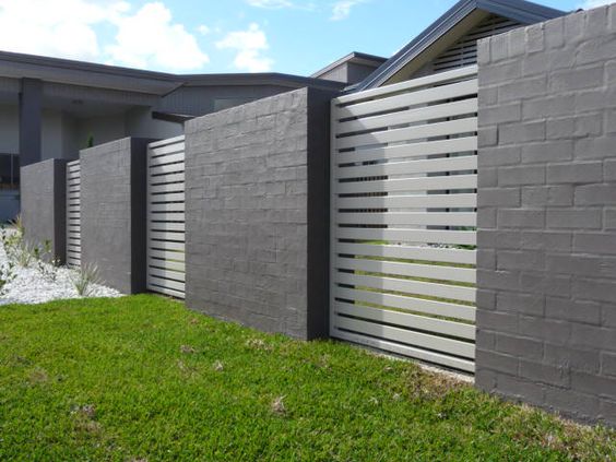 A house with a grey slatted fence.