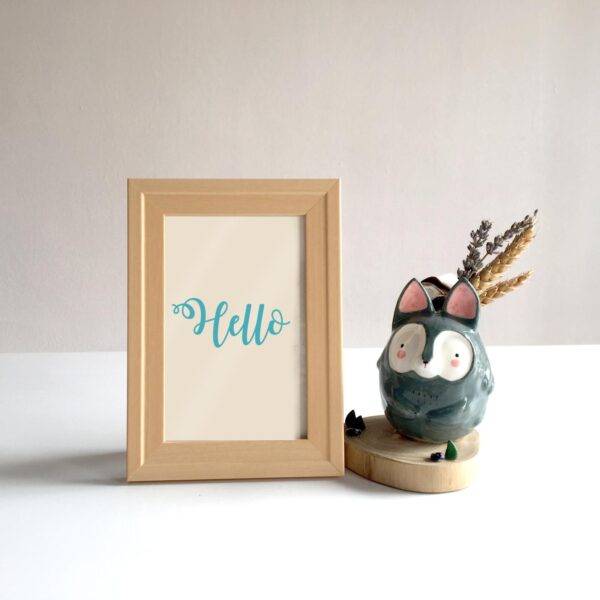 A wooden frame featuring an owl, perfect for displaying as art in a living room.